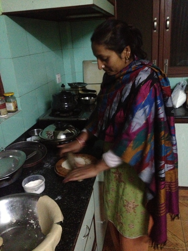 Aama rolling chapati.