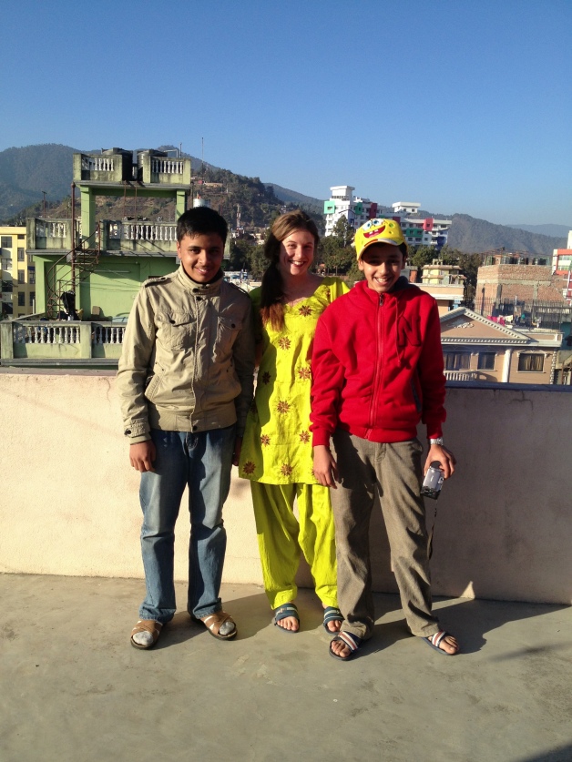 My host brothers and me. And why yes I AM wearing traditional Nepali clothes! My very neon Christmas gift from the Pandeys.